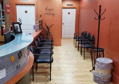 Other view of entryway with wood floors and copper-colored walls